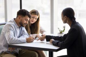 A family lawyer explaining to a couple how much it will cost them to finalize their divorce in Connecticut