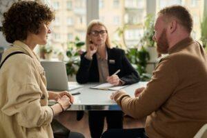 A couple getting divorced, asking their attorney what the average divorce settlement in CT covers