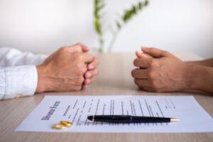 A couple discusses how long their divorce in CT will take while looking at a divorce form.